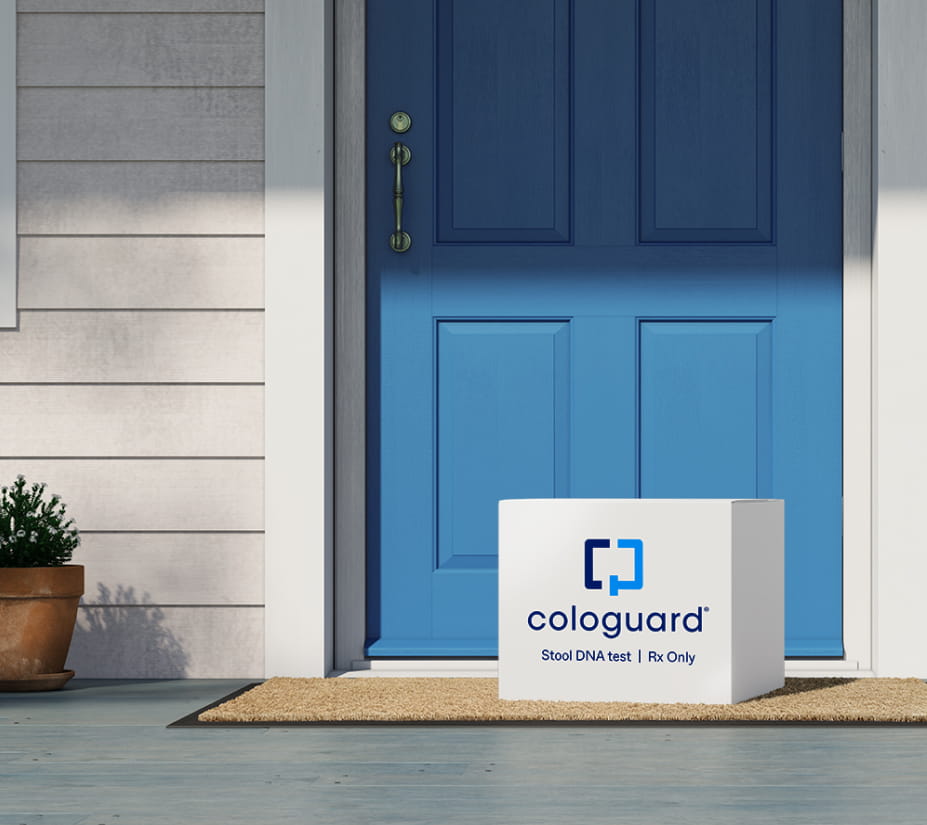 Cologuard stool DNA test kit delivered to a welcome mat in front of a blue door.