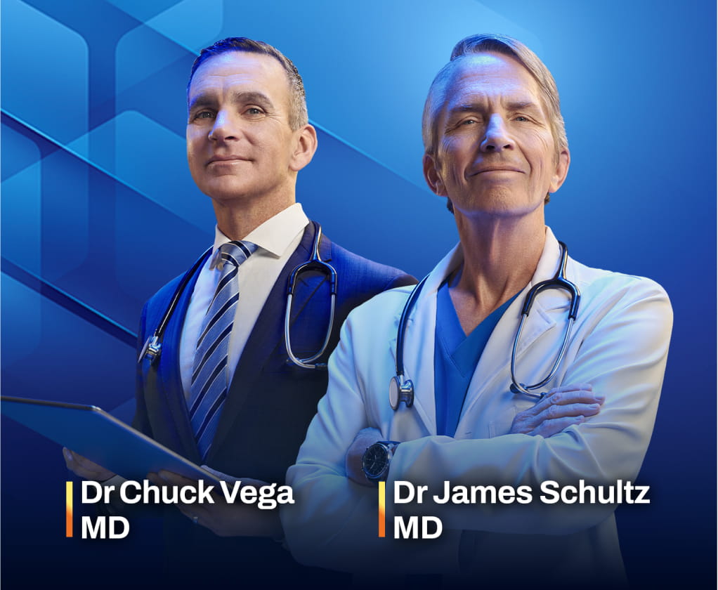 Dr Chuck Vega, MD, and Dr James Schultz, MD, in medical attire stand together against a blue background.